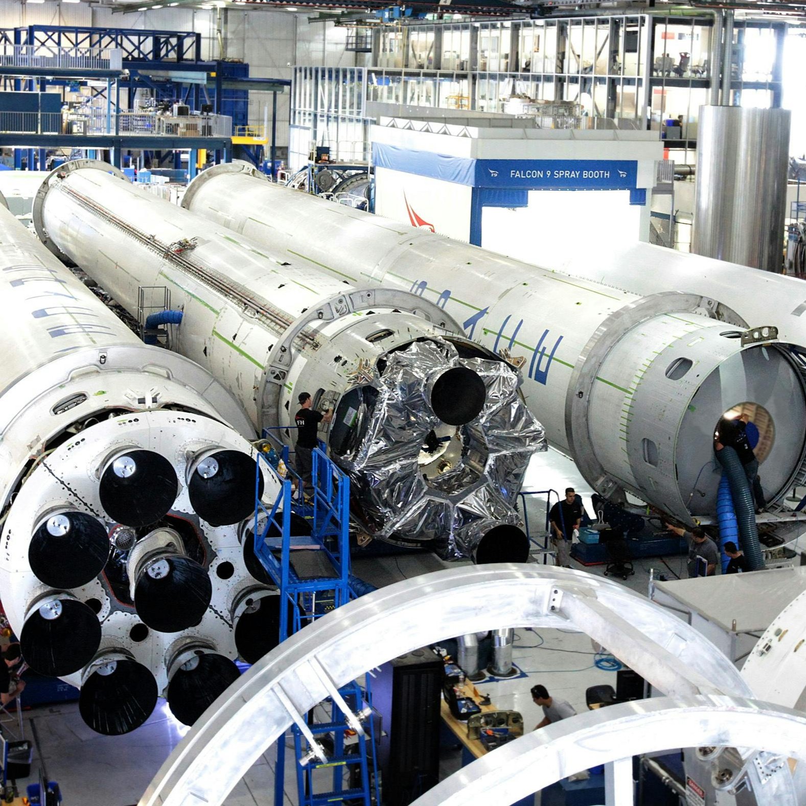 AS6500 - Men working on giant rocket tubes