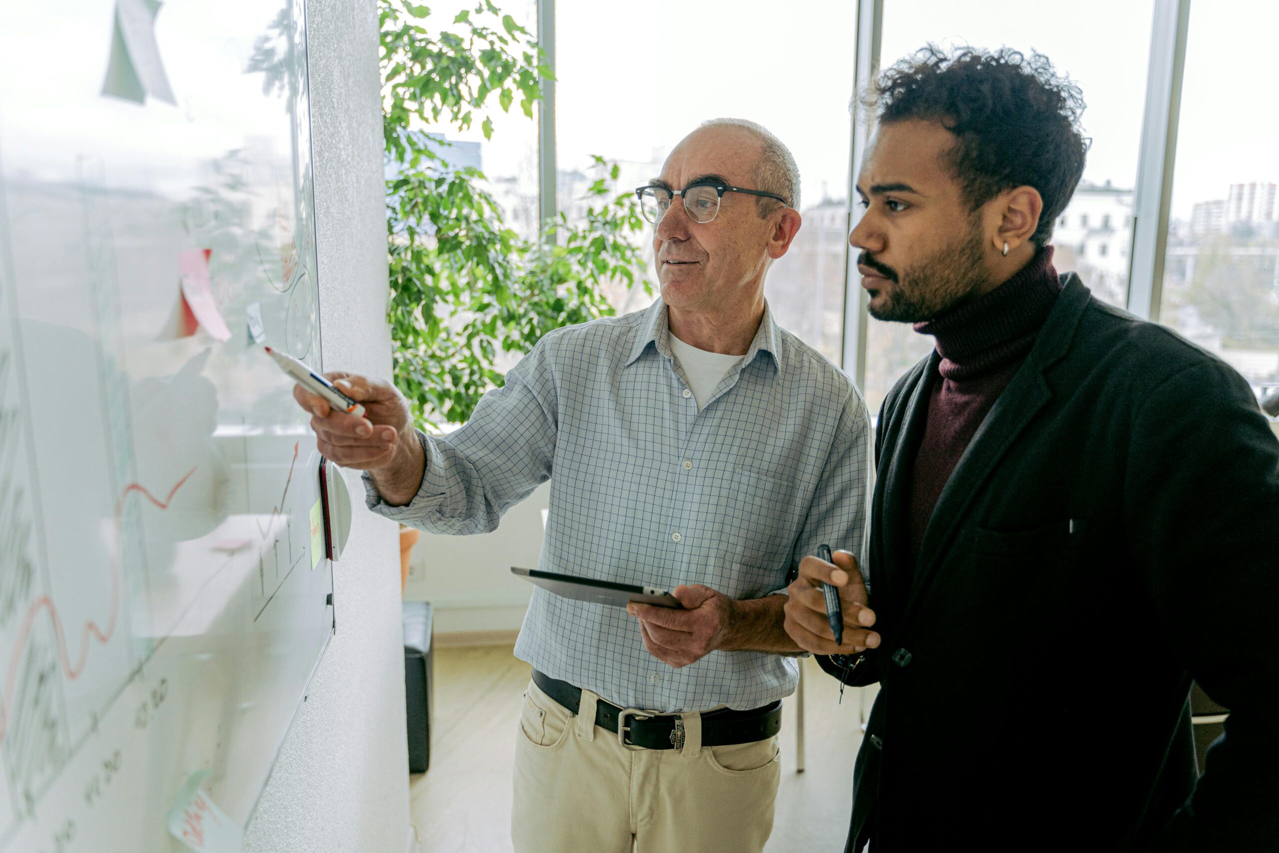CAPA Training - Two men working on a white board