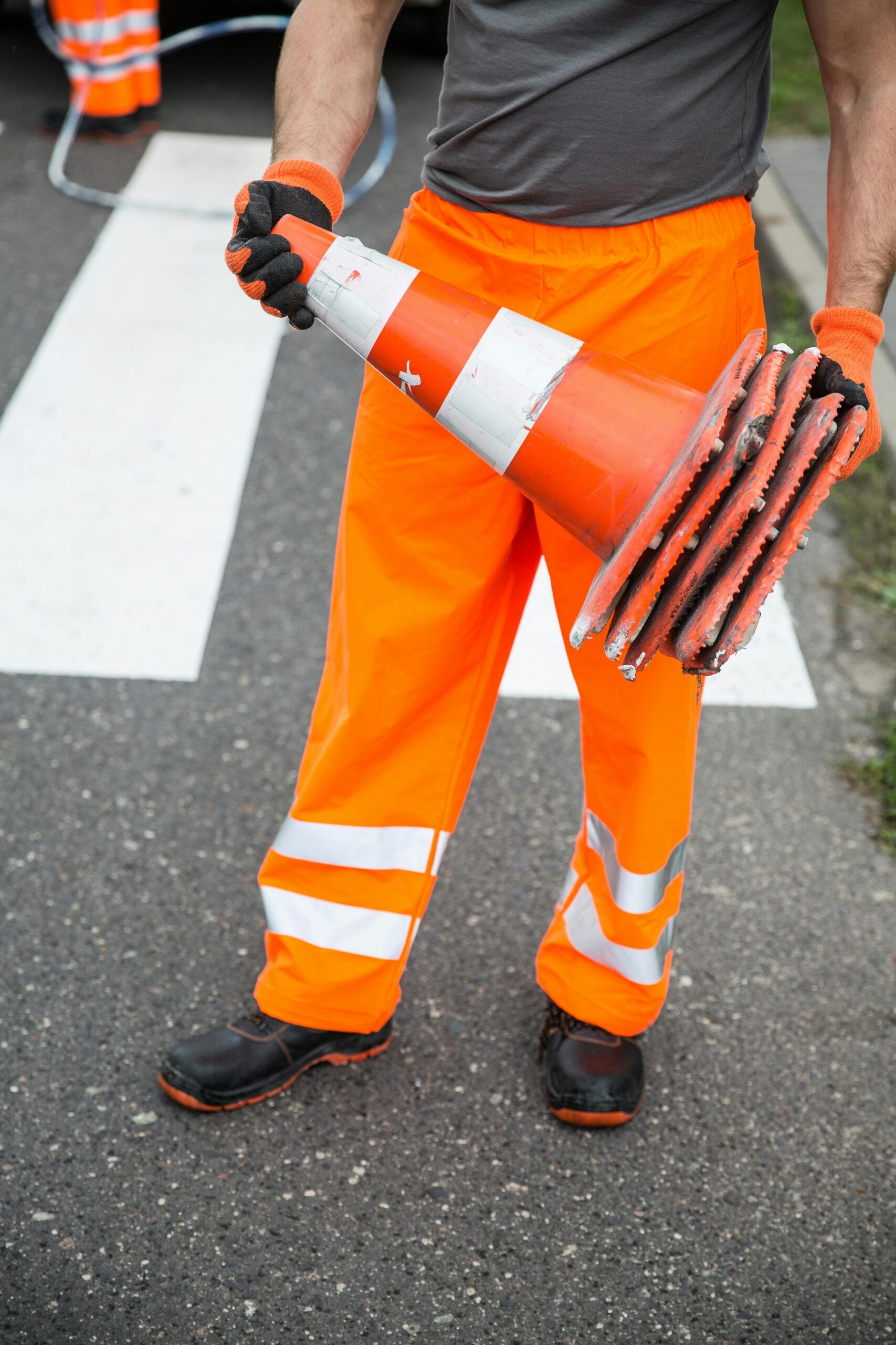 ISO 45001 Lead Auditor Training - Man holding orange cones and wearing reflective orange pants