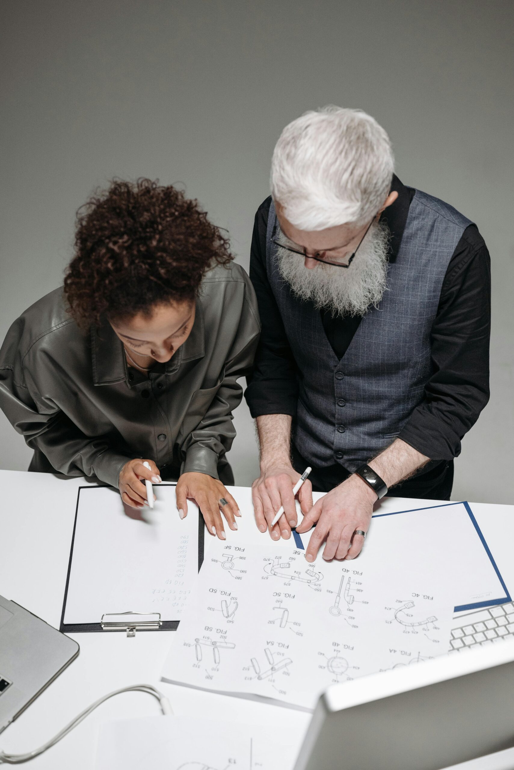 Design Control - Two people looking at a piece of paper with designs and making notes